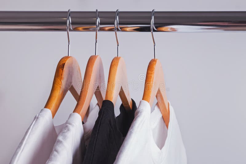 Black Wooden Hangers Hanging On Rack Rail Stock Photo, Picture and Royalty  Free Image. Image 32578781.