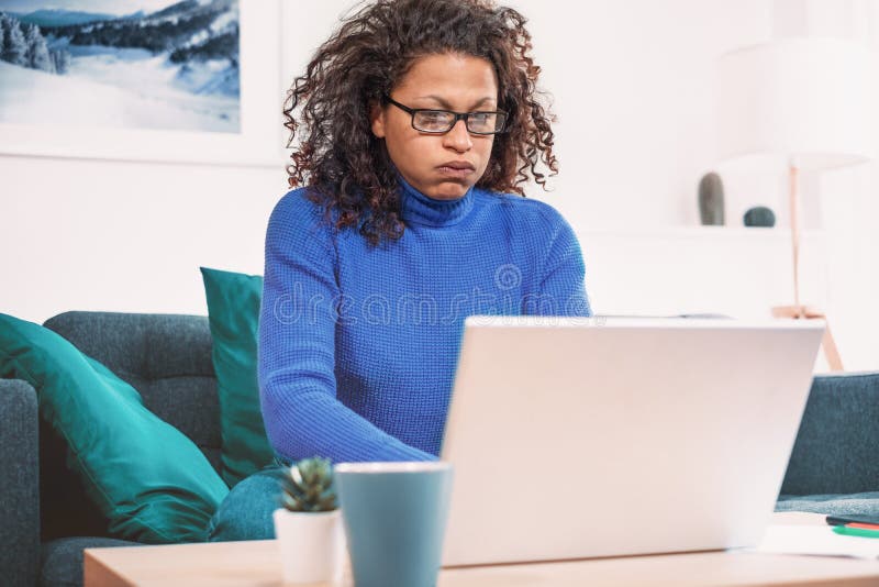 One black woman working from home using laptop