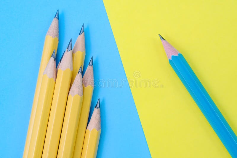One Blue Pencil and Group of Yellow Pencils. Individuality Concept