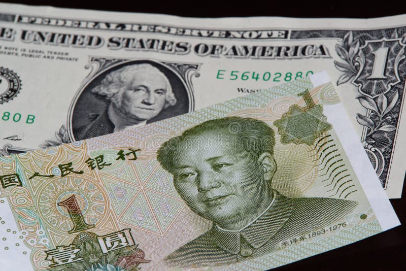 One Chinese yuan banknote above one american dollar on black background. One Chinese yuan banknote is above one american dollar on black background stock photo One Chinese yuan banknote above one american dollar on black background. One Chinese yuan banknote is above one american dollar on black background stock photo