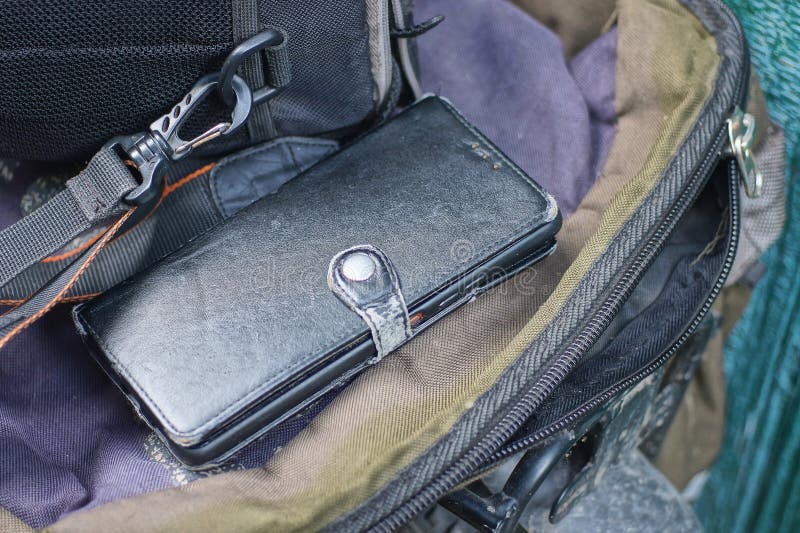 One closed rectangular black leather case with a smartphone royalty free stock photography