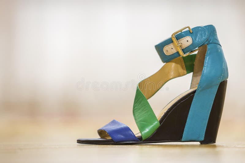 One colorful bright blue, green and yellow leather strap female shoe sandal on high black platform isolated on light copy space. Background. Style and fashion royalty free stock photos One colorful bright blue, green and yellow leather strap female shoe sandal on high black platform isolated on light copy space. Background. Style and fashion royalty free stock photos