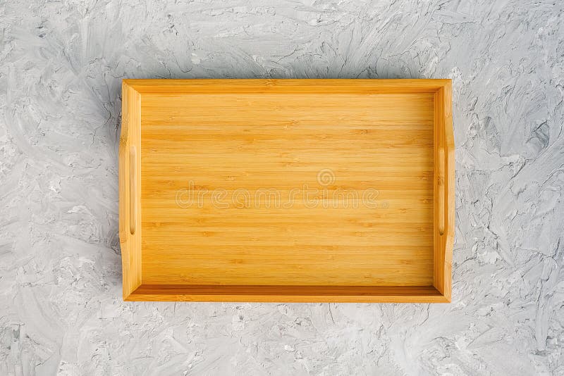 One empty wooden tray on gray stone table. Top view Mock up royalty free stock photos