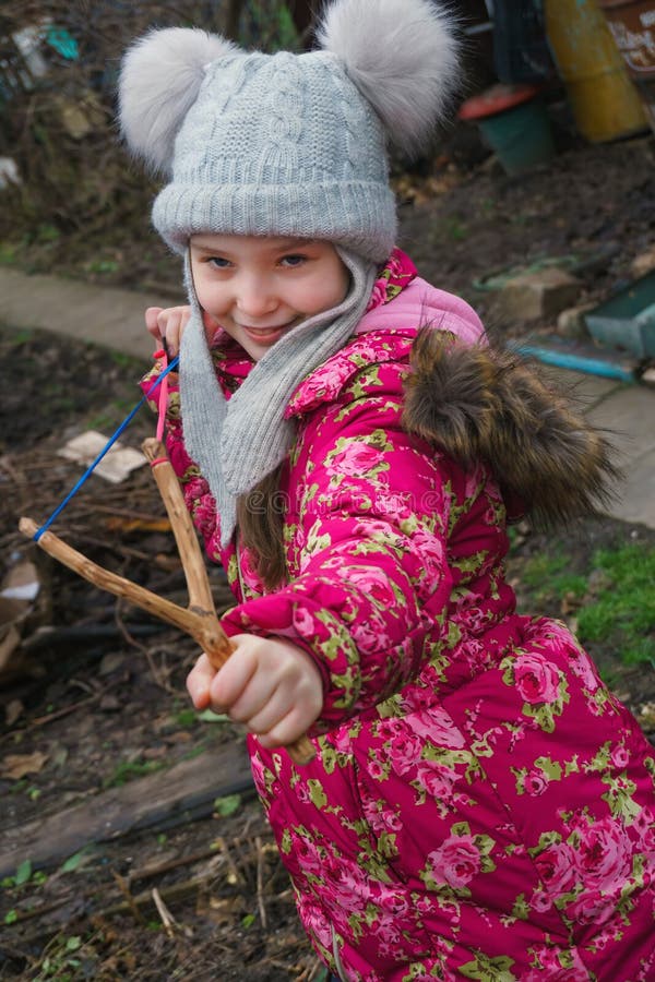 Girl aiming of slingshot stock photo. Image of looking 107635888
