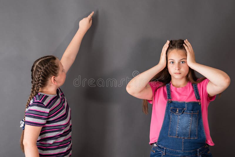 One girl is amazed at how easy and beautiful the other solves th royalty free stock photos One girl is amazed at how easy and beautiful the other solves th royalty free stock photos