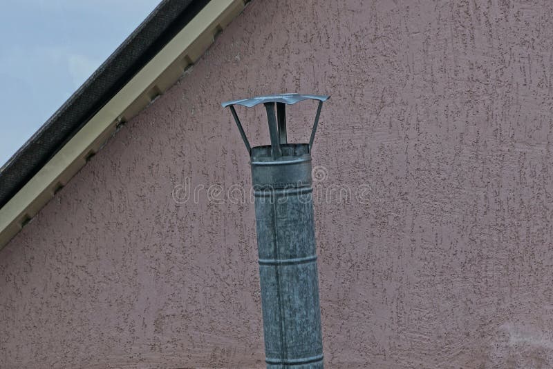 One Gray Long Metal Chimney Pipe on the Brown Wall Stock Photo Image