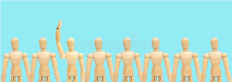 One in group of wooden figure mannequin rise hand up on blue background. stock image One in group of wooden figure mannequin rise hand up on blue background. stock image