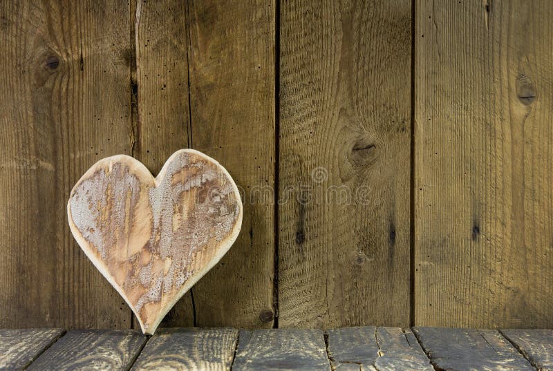 One heart of wood on a old rustic background for a greeting card.