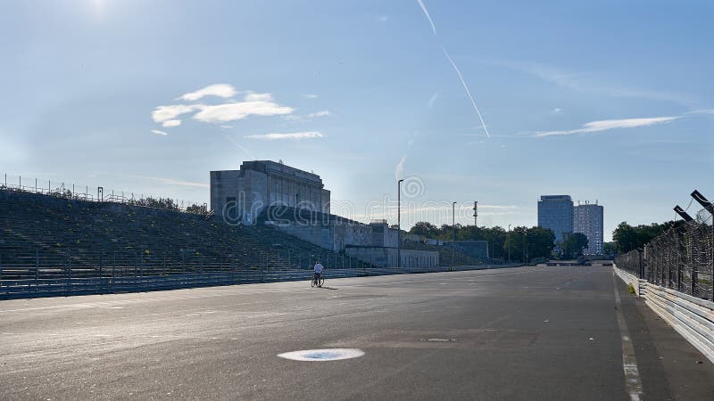 A lone cyclists takes in the expanse of emptiness of the abandoned Nuremburg Rally Grounds made famous in the 1930`s by Adolf Hilter. Nuremburg, Germany. August 2019. A lone cyclists takes in the expanse of emptiness of the abandoned Nuremburg Rally Grounds made famous in the 1930`s by Adolf Hilter. Nuremburg, Germany. August 2019.