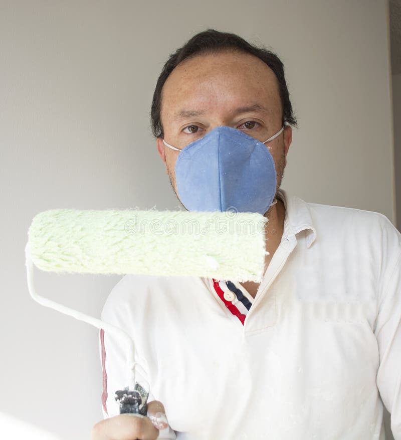 Male House Painter Worker Painting and Priming Wall with Painting