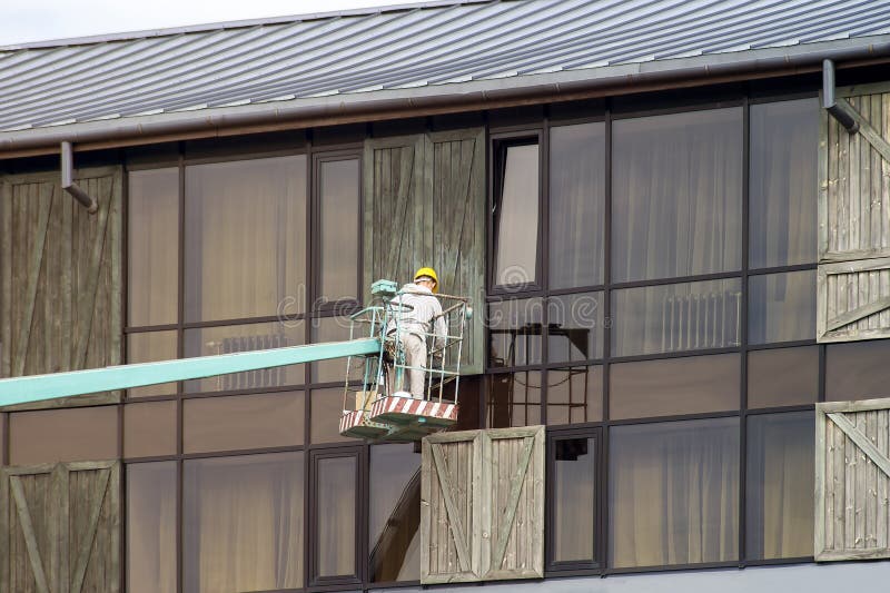 window cleaner has his helmet polished