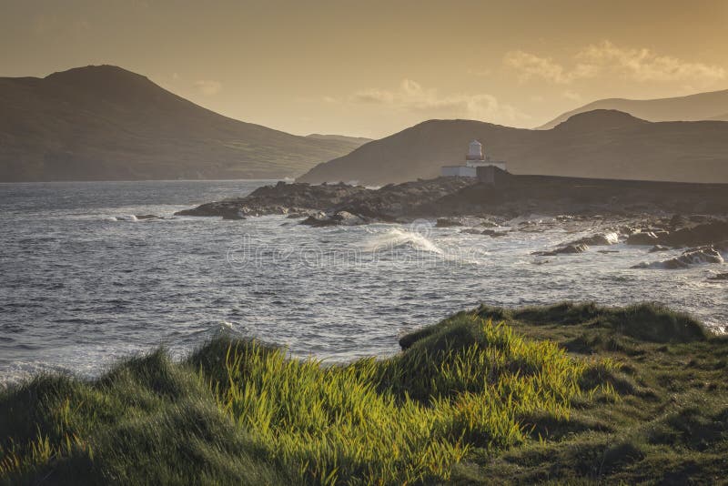 Sunrise at the Lighthouse near Ring of Kerry in Irland, at the shore of the Atlantic Ocean