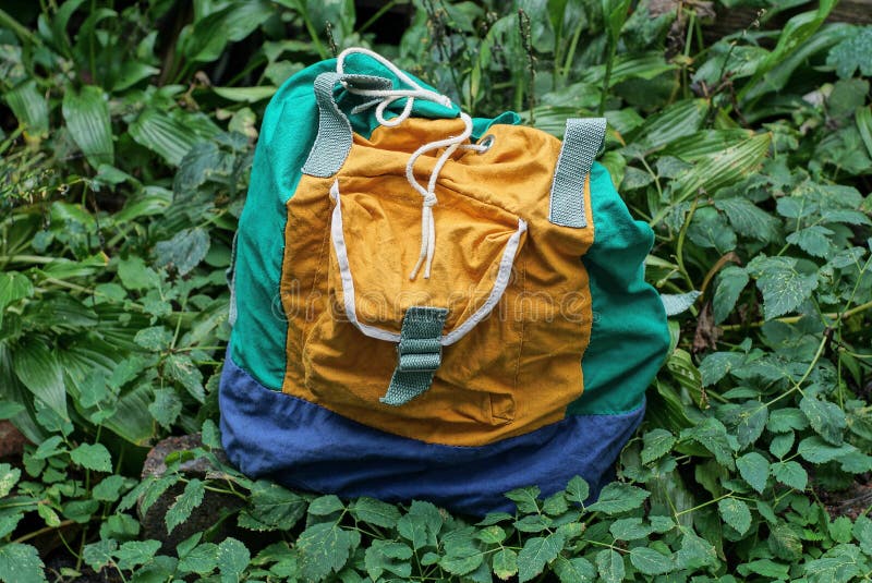 One Old Full Colored Backpack Made of Fabric Stands in Green Grass Stock Photo Image of greens