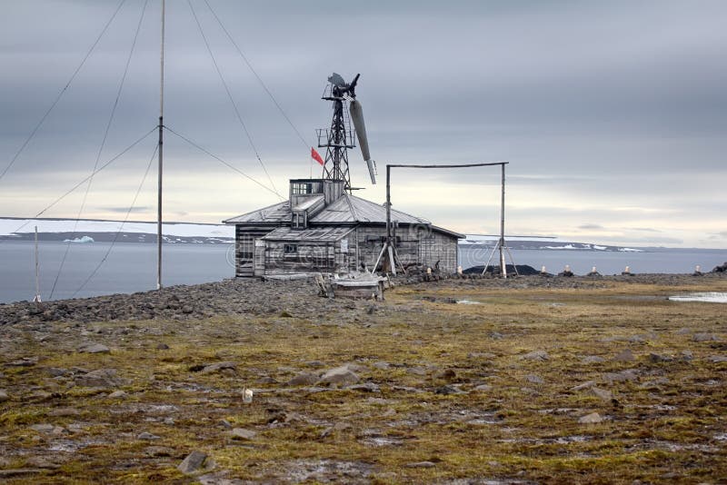 One of oldest polar stations in Arctic. Franz Josef Land. Severe land. One of the oldest polar stations in Arctic founded in 1928, now abandoned. Wooden houses stock photo One of oldest polar stations in Arctic. Franz Josef Land. Severe land. One of the oldest polar stations in Arctic founded in 1928, now abandoned. Wooden houses stock photo