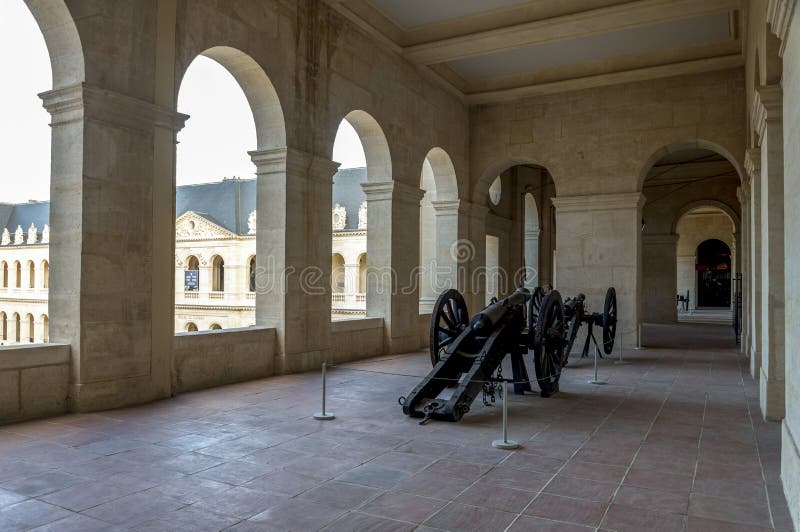 One of the outside corridors in the Army museum with old military cannons, Les Invalides complex, Paris royalty free stock image One of the outside corridors in the Army museum with old military cannons, Les Invalides complex, Paris royalty free stock image