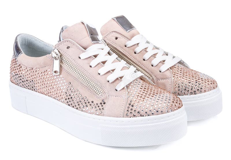 One pair of golden sneakers isolated on white background. stock images One pair of golden sneakers isolated on white background. stock images