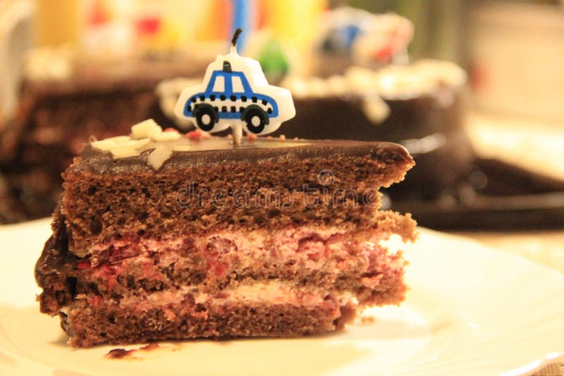One piece of festive chocolate cake with a candle stock images One piece of festive chocolate cake with a candle stock images
