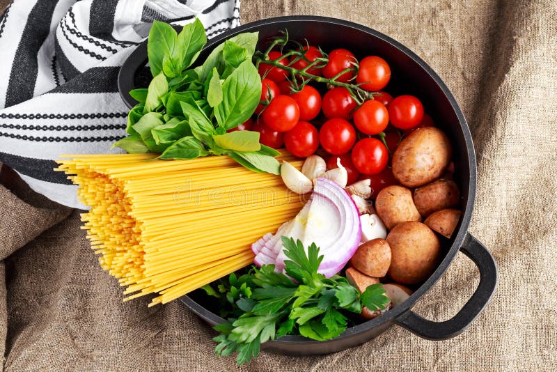 One pot pasta with basil, cherry tomatoes, red onion, garlic, parsley, mushrooms.