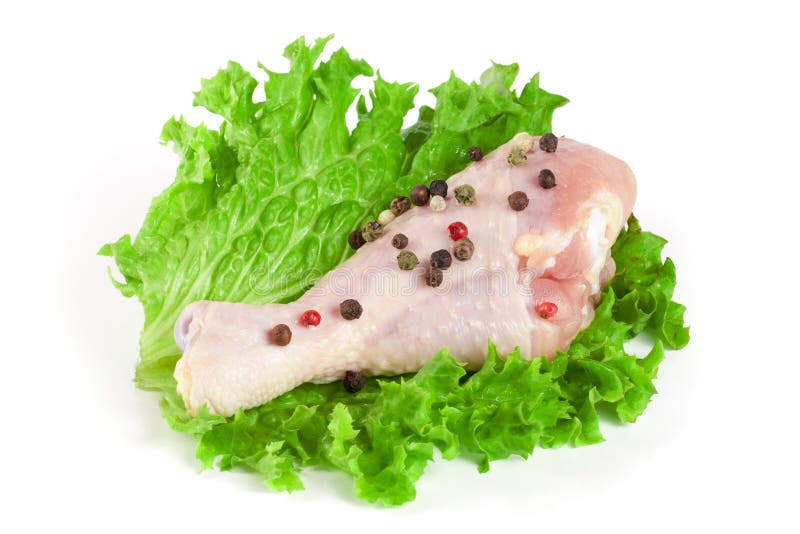 One raw chicken drumstick with lettuce leaf isolated on white background stock photo One raw chicken drumstick with lettuce leaf isolated on white background stock photo