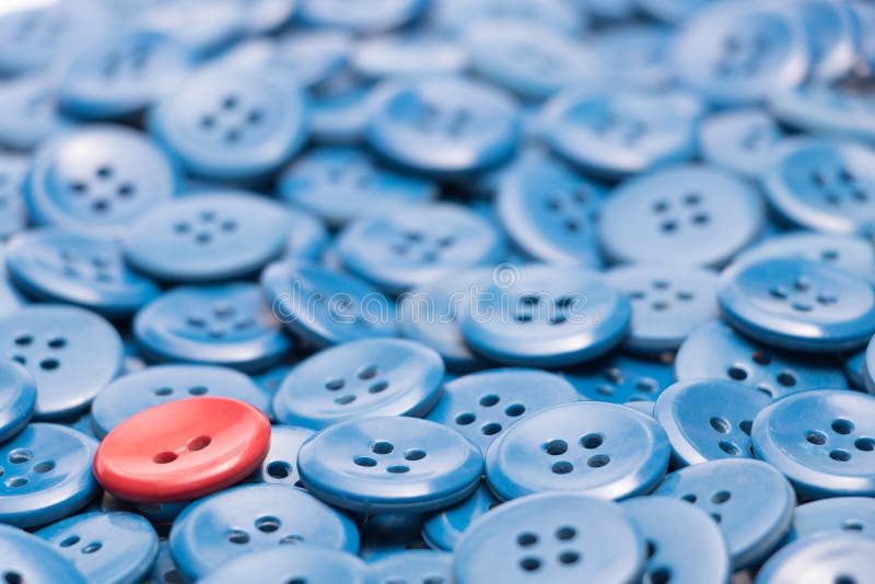 One red button on a heap of blue buttons left based