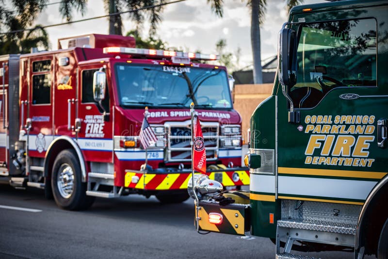 one-red-and-one-dark-green-fire-truck-with-american-and-fire-department