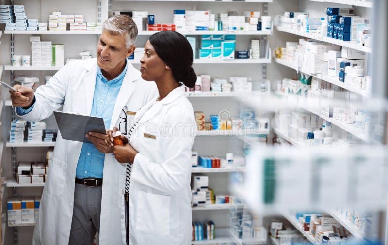 This one sells fast. two pharmacists working together in a drugstore.