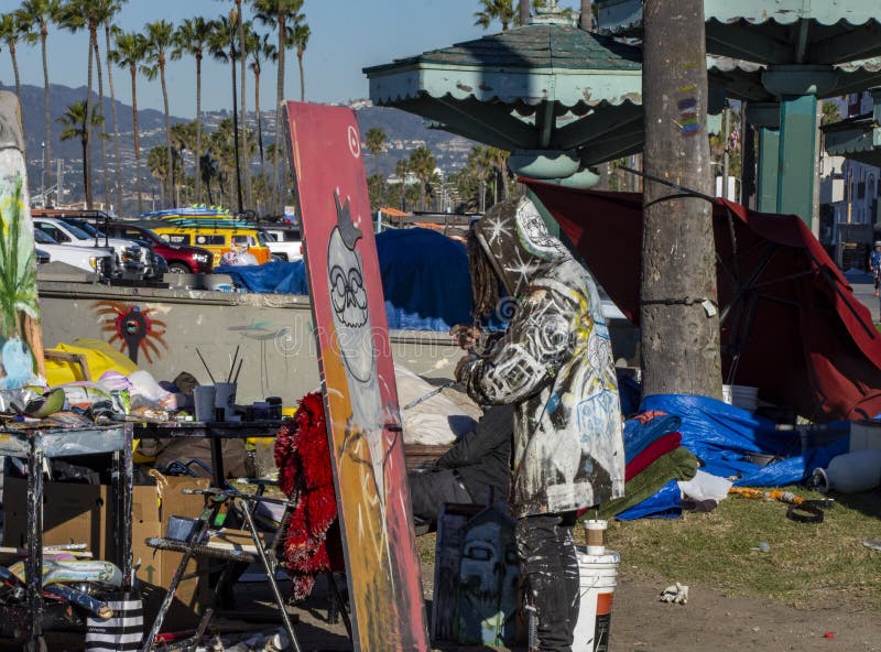 One of several artist in Venice painting a picture in Venice Beach, California.  Venice Beach is considered a cultural link for the rest of LA. Throughout the years, it has been known to be a hub of artistic inspiration and creativity.  It is also a place of rampant homelessness. One of several artist in Venice painting a picture in Venice Beach, California.  Venice Beach is considered a cultural link for the rest of LA. Throughout the years, it has been known to be a hub of artistic inspiration and creativity.  It is also a place of rampant homelessness.