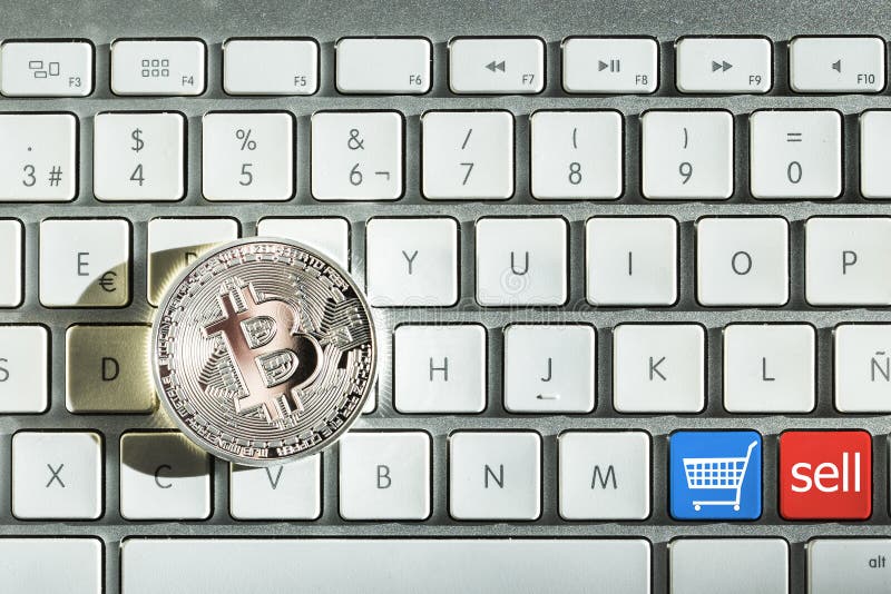 One silver bitcoin in keyboard and buttons sell and buy. Keyboard sell stock images, royalty-free photos and pictures