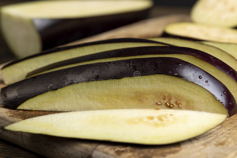 One sliced ripe eggplant on the table royalty free stock image