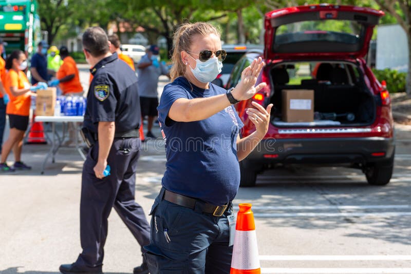 One Team - One Mission, Food Distribution with Coral Springs Police Department officers and Coral Springs Fire Department stock images One Team - One Mission, Food Distribution with Coral Springs Police Department officers and Coral Springs Fire Department stock images