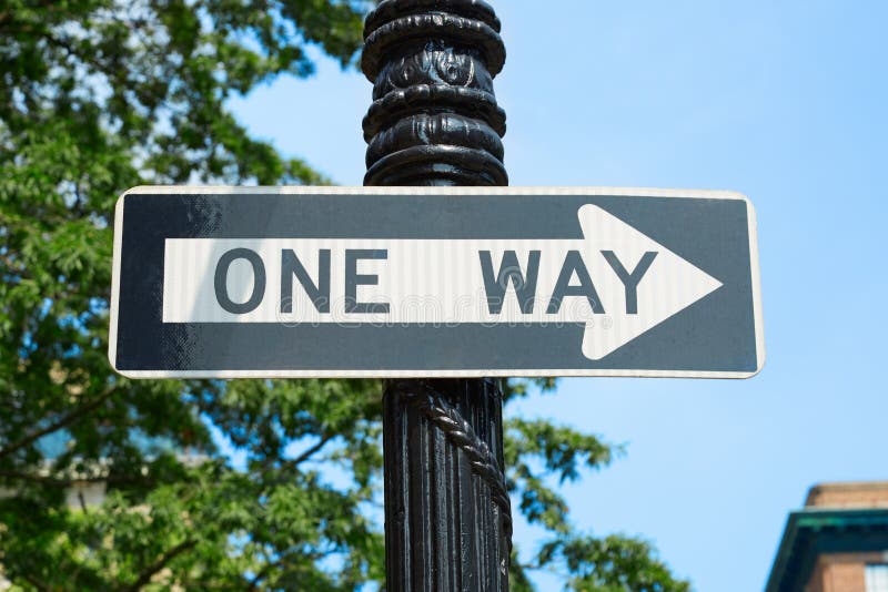 One way street sign in New York with green tree branches stock images One way street sign in New York with green tree branches stock images