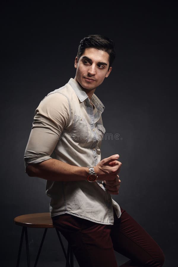 One young handsome man, handsome model, 20-29 years old, posing in studio, photo shoot. black background. casual clothes. wearing royalty free stock photo One young handsome man, handsome model, 20-29 years old, posing in studio, photo shoot. black background. casual clothes. wearing royalty free stock photo