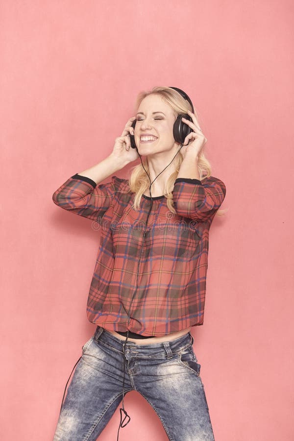 One young woman, hilarious laughing emotion, hilarious listening to music on headphones. royalty free stock photography One young woman, hilarious laughing emotion, hilarious listening to music on headphones. royalty free stock photography