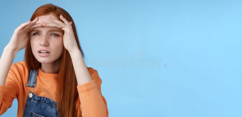 Worried clingy redhead girlfriend spying boyfriend peer from distance squinting focus sight look afar hold hands forehead cover eyes sunlight standing concentrated blue background. Worried clingy redhead girlfriend spying boyfriend peer from distance squinting focus sight look afar hold hands forehead cover eyes sunlight standing concentrated blue background.