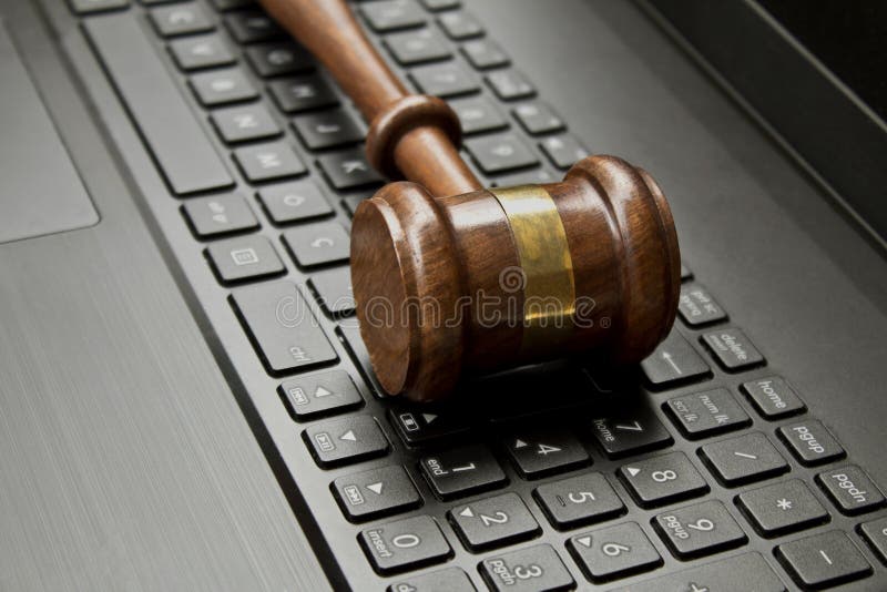 judge gavel on a computer keyboard. stock photo judge gavel on a computer keyboard. stock photo