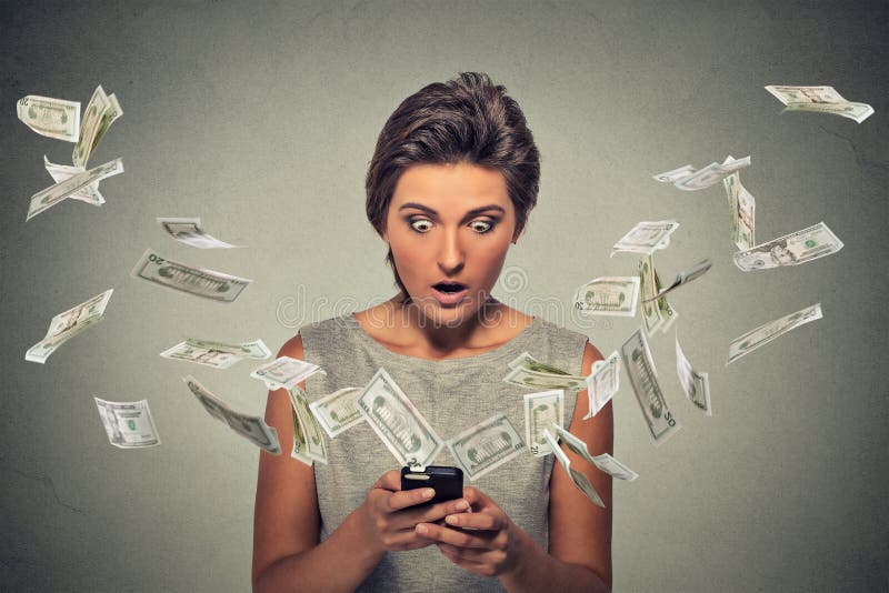 Online banking concept. Shocked woman using smartphone dollar bills flying away stock photography Online banking concept. Shocked woman using smartphone dollar bills flying away stock photography