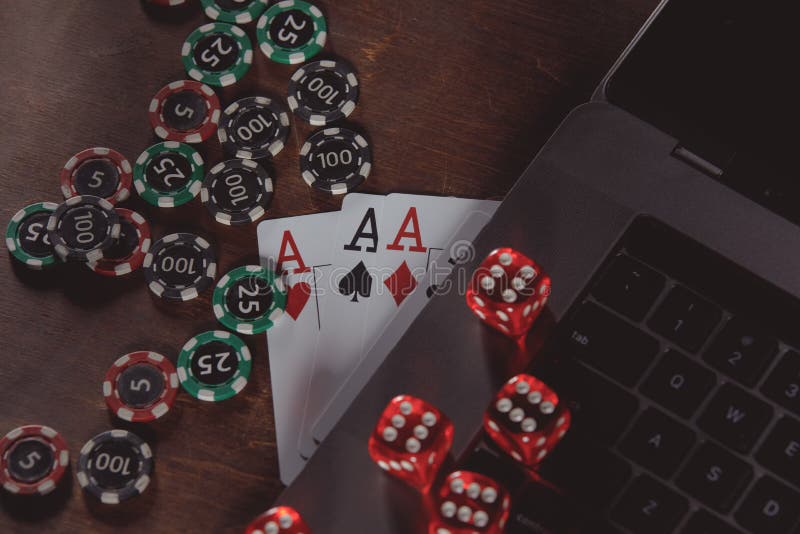 Online casino concept. Playing chips, dices and cards on a wooden background