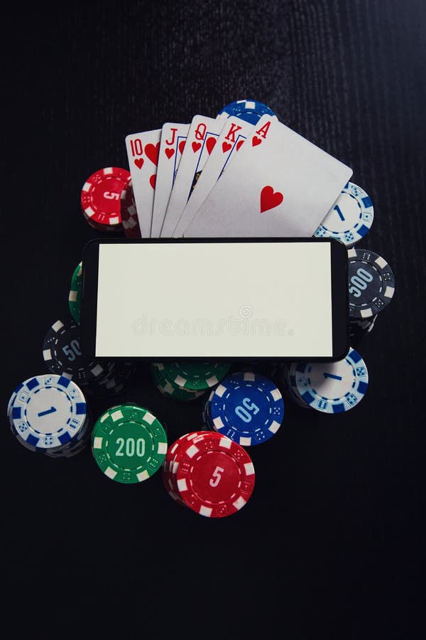Online casino gambling concept. Smartphone blank screen on chips stack and royal flush playing cards poker combination over black stock photos Online casino gambling concept. Smartphone blank screen on chips stack and royal flush playing cards poker combination over black stock photos