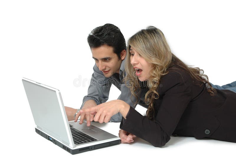A Happy Diverse couple on white background laying on the floor and doing internet shopping. Facial expressions of shopping consumers. A Happy Diverse couple on white background laying on the floor and doing internet shopping. Facial expressions of shopping consumers.