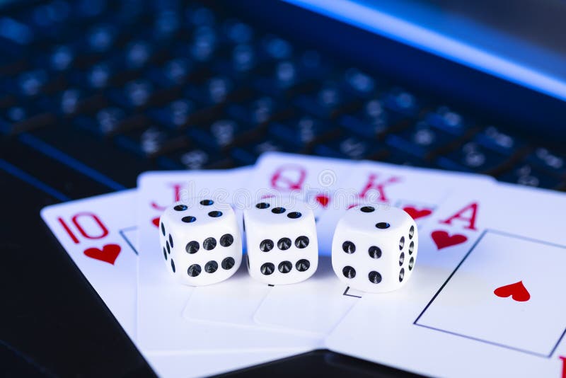 Online gaming platform, casino and gambling business. Cards, dice and  multi-colored game pieces on laptop keyboard. Sports & Recreation Stock  Photos
