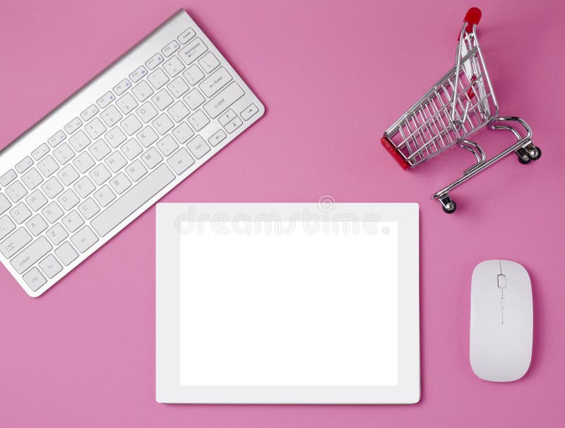 Feminine workplace concept. Shopping cart and tablet. Online shopping concept. Items on bright pink background, top view. a tablet on a pink table. Flat lay. Copy space. White tablet on the pink table with succulent, key board and mouse. Feminine workplace concept. Shopping cart and tablet. Online shopping concept. Items on bright pink background, top view. a tablet on a pink table. Flat lay. Copy space. White tablet on the pink table with succulent, key board and mouse.