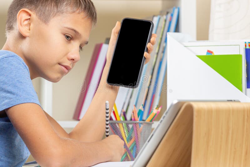 Teen boy distracting from online lesson and playing video games, scrolling  phone. Learning difficulties, online education, entertainment at home Stock  Photo - Alamy