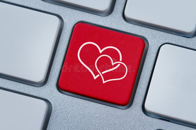 Close up of red computer key with two hearts symbol on it. Close up of red computer key with two hearts symbol on it