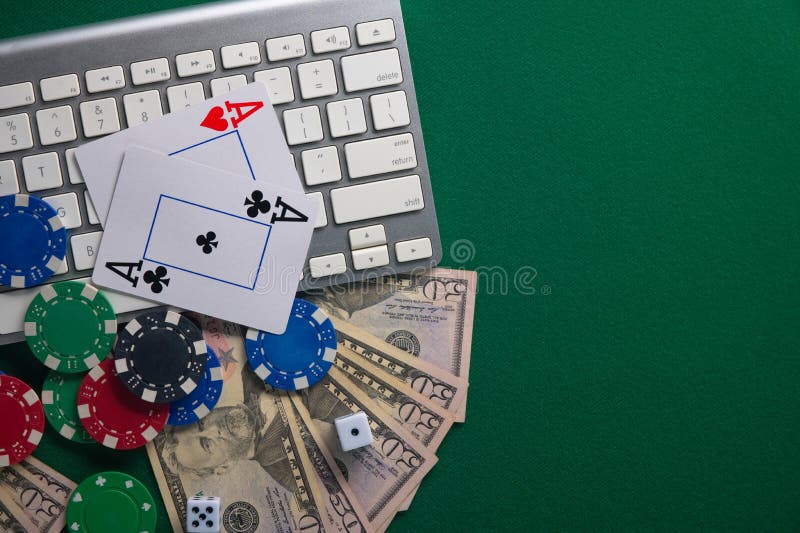 Online Poker. Chips and the Dice Nearby Keyboard on Green Table Top