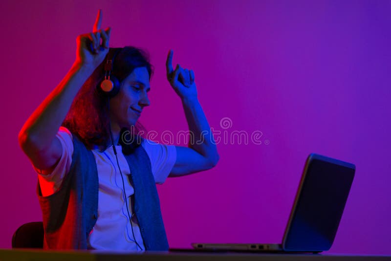 Online Programming Training, Computer Programmer or Student. a Young Man  with Long Hair and Headphones Stock Photo - Image of nerd, neon: 204233346