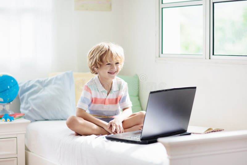 Online remote learning. School kids with computer stock image