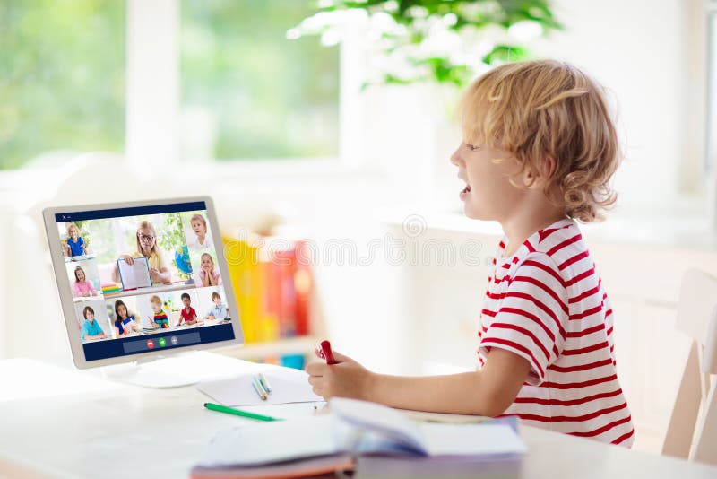 Online remote learning. School kids with computer stock photo