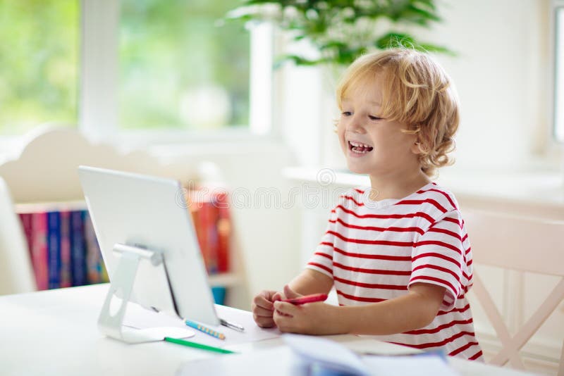 Online remote learning. School kids with computer stock image