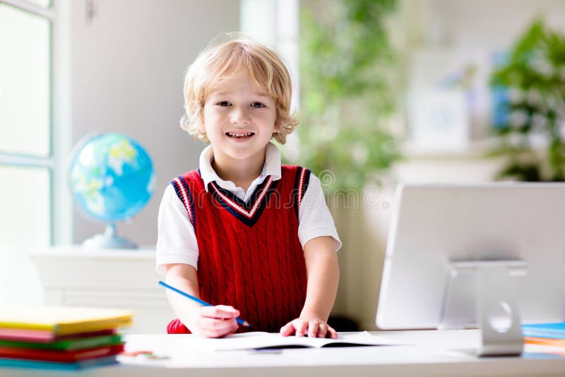 Online remote learning. School kids with computer stock photography