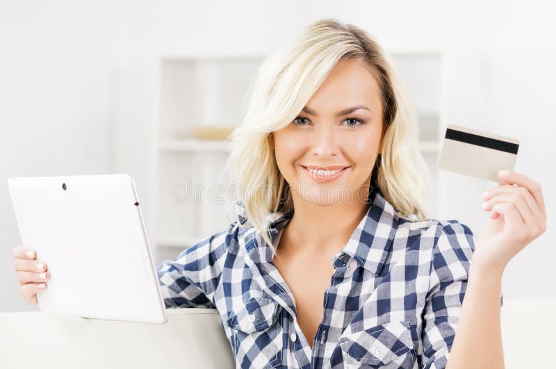 Online shopping concept. Beautiful blond girl with a credit card